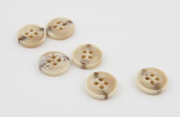 Polished casein buttons