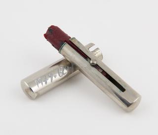 Red lipstick in metal cylinder