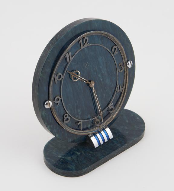 Circular clock with ovoid base of imitation lapis lazuli casein