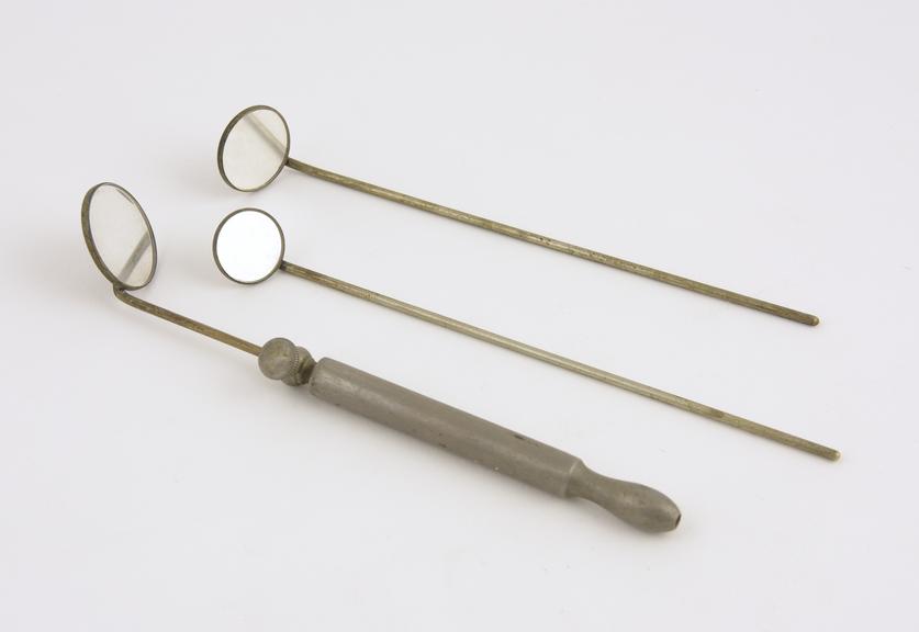 Three laryngeal mirrors with nickel-plated handle, British (?)