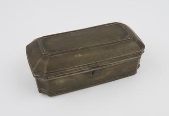 Brass tin containing moss, chalk, and shells