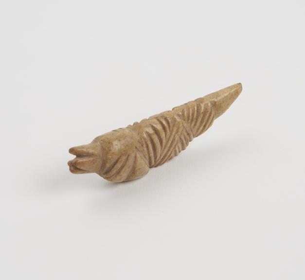 Bone pendant, amuletic, shaped like dolphin, phallic