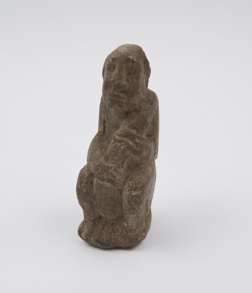 Seated stone phallic figure