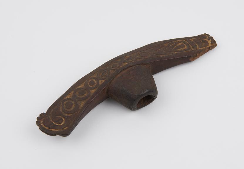 Carved wooden implement