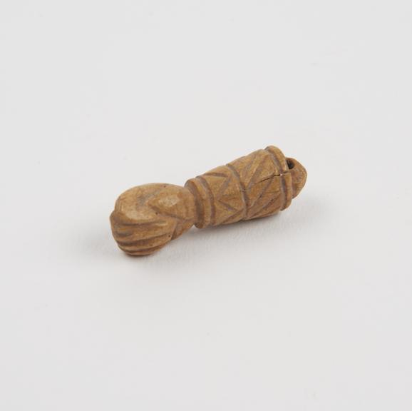 Amuletic ivory(?) pendant in form of hand in phallic fig