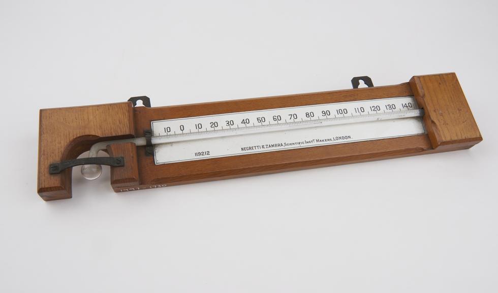 Alcohol-in-glass thermometer mounted on wood