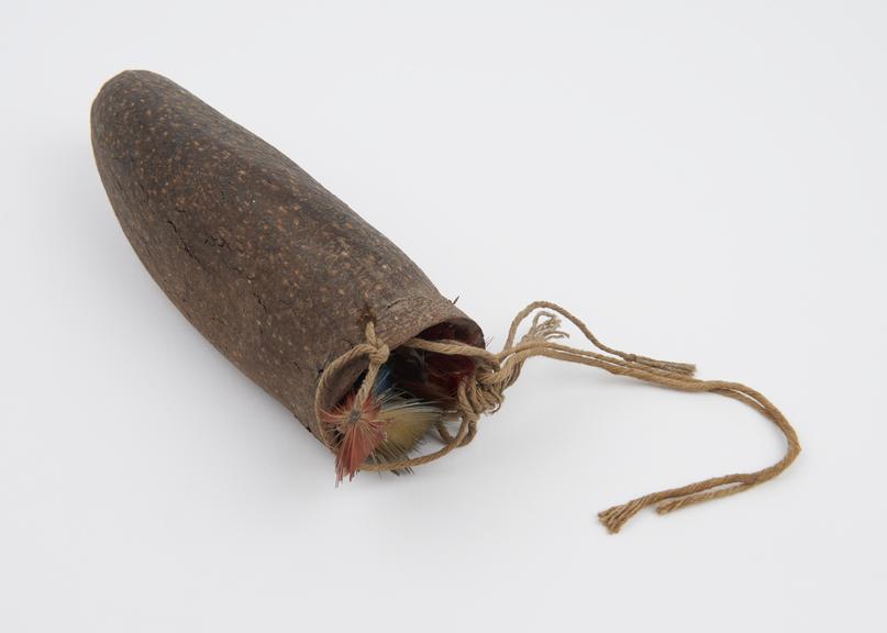 Penis sheath made from dried fruit shell with string and