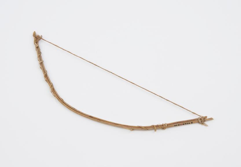 Miniature bow, wood and fibre, used with arrow in blood letting