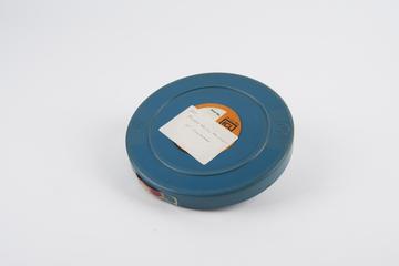 Reel of film in lidded can: '40 column equipment at Gallaghers1'