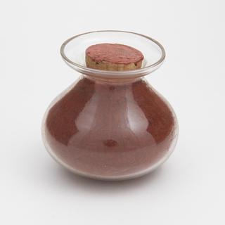 Sample bottle containing red powder