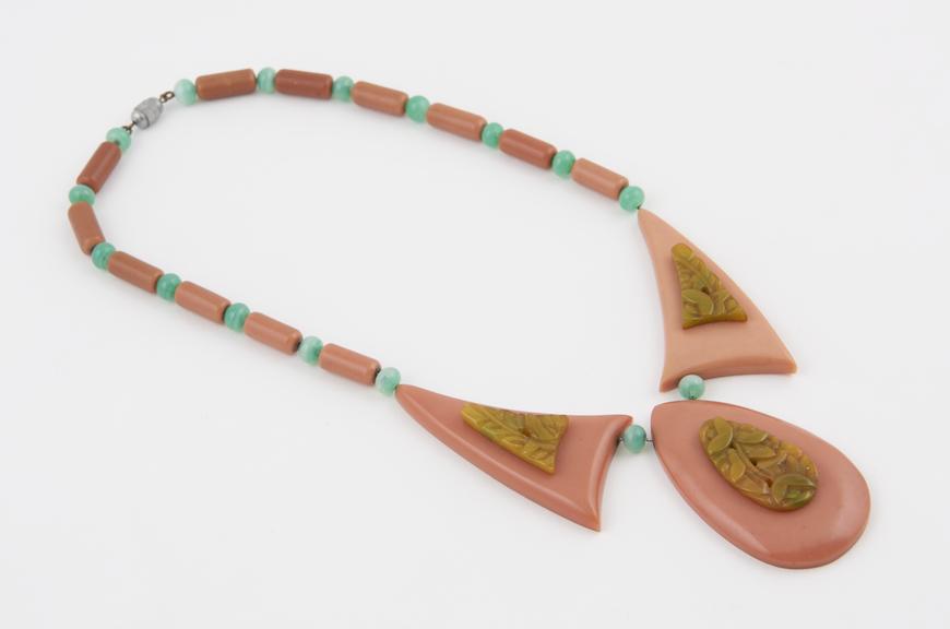 Necklace made of coral coloured casein mounted with cast