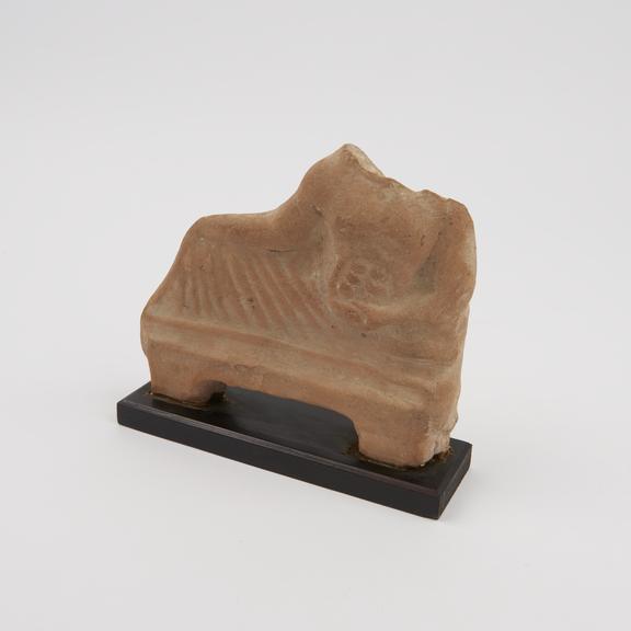 Votive plaque in form of reclining man, terracotta