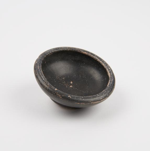 Small shallow black-glazed dish