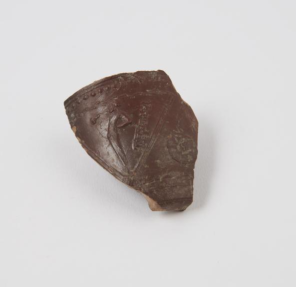 Fragment of brown glazed pottery bowl (bowl)