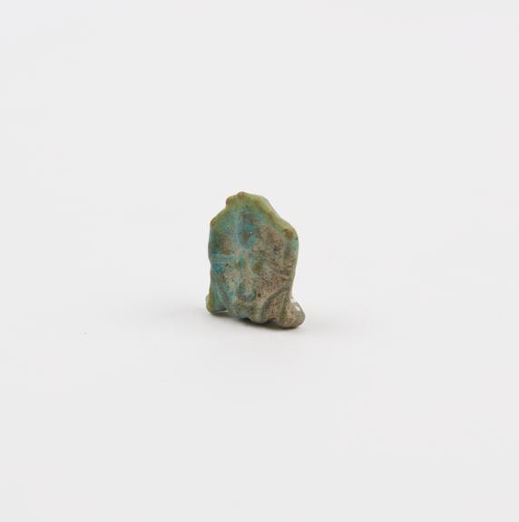 Small blue faience amulet in form of squatting female figure