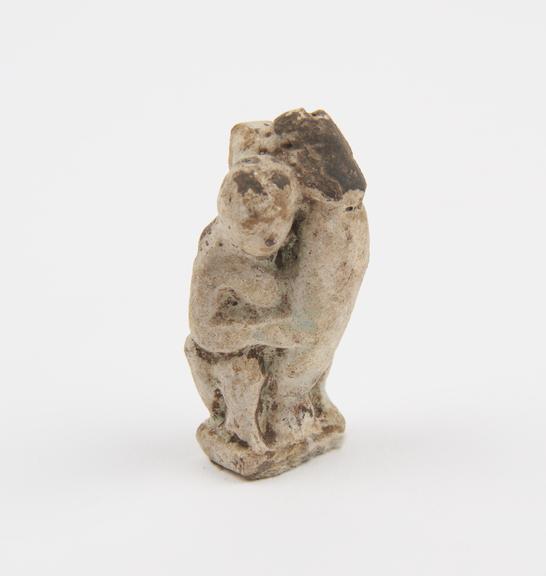 Faience amuletic pendant in form of seated phallic figure