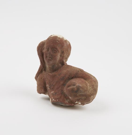 Broken fragment of unglazed hollow terracotta phallic figure with traces of paint