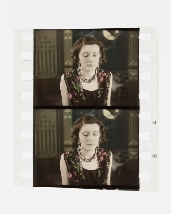 Two frames of silent 35mm stencil colour positive film showing