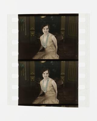 Two frames of silent 35mm stencil colour positive film