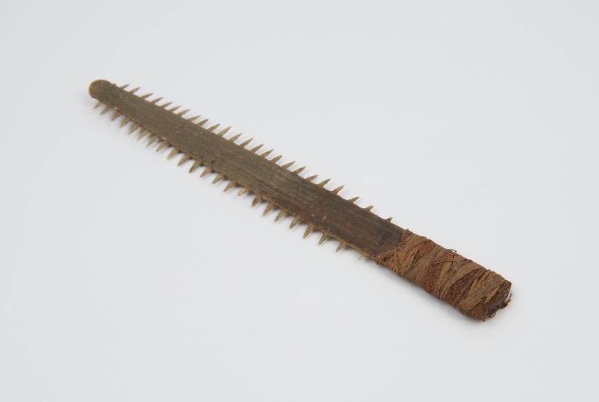 Saw, consisting of snout of saw-fish, one end bound with fibre