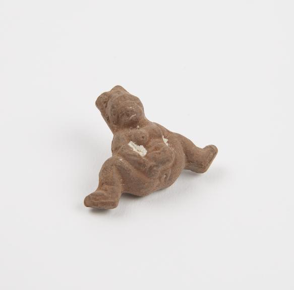 Unglazed moulded terracotta fertility figure with traces of engobe