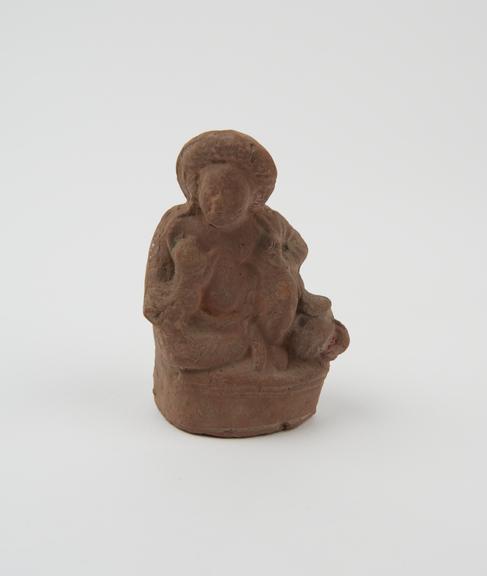 Hollow terracotta votive(?) figure, seated