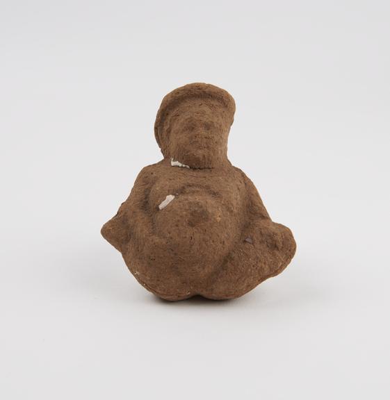 Solid terracotta figure of fat squatting female(?)