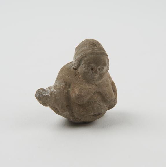 Small unglazed hollow terracotta female fertility figure with traces of engobe