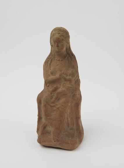 Terracotta votive figurine representing seated female suckling