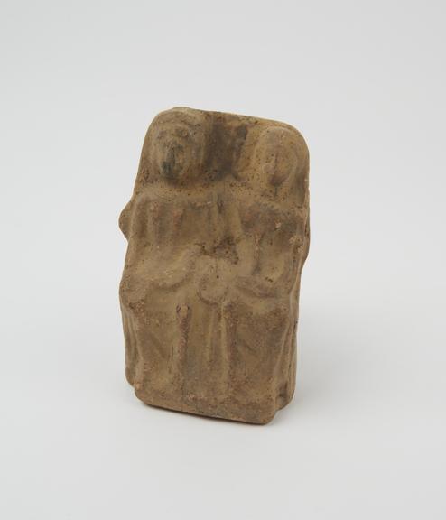 Votive group of man, woman and child, seated, terracotta