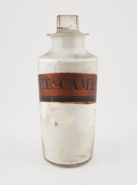 Bottle, clear glass, with contents for camphorated chalk