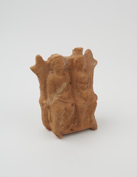 Votive statue, seated man and woman with child, terracotta