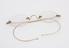 Rimless gold spectacles with oval lenses and single piece hook