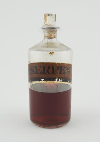 Bottle, clear glass half-full for tincture of serpentary
