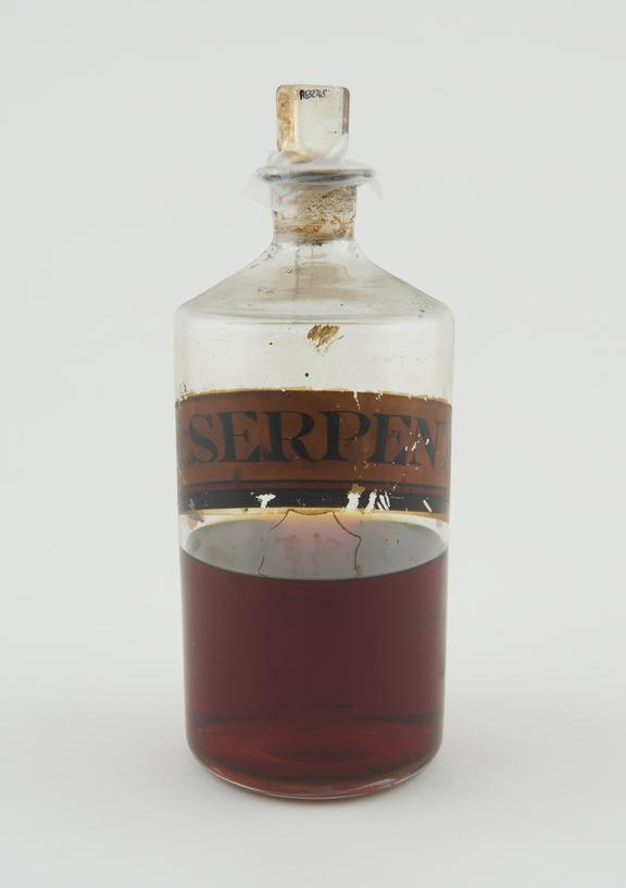 Bottle, clear glass half-full for tincture of serpentary