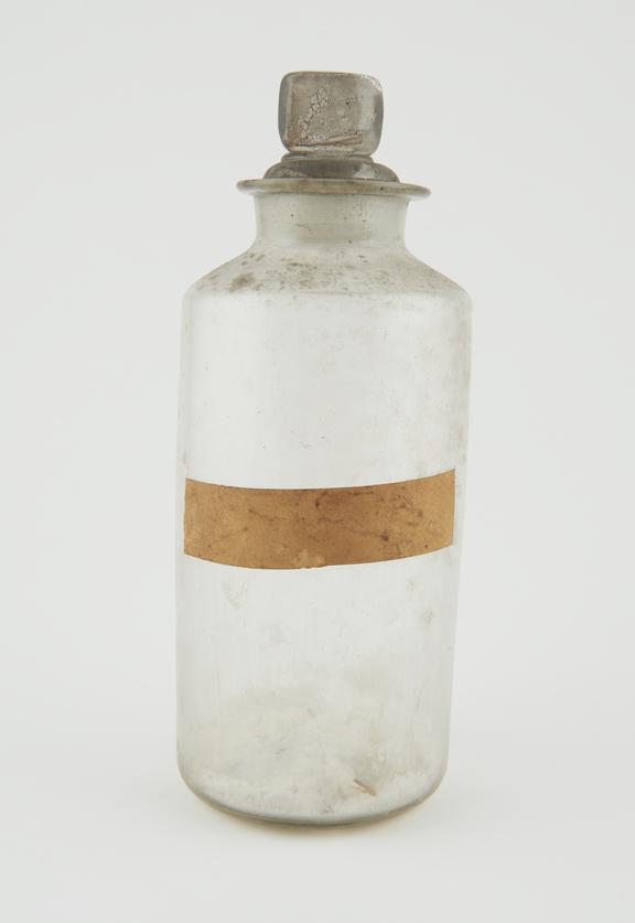 Bottle, clear glass, with contents, English, late 19th century