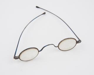 Spectacles with small thick oval lenses