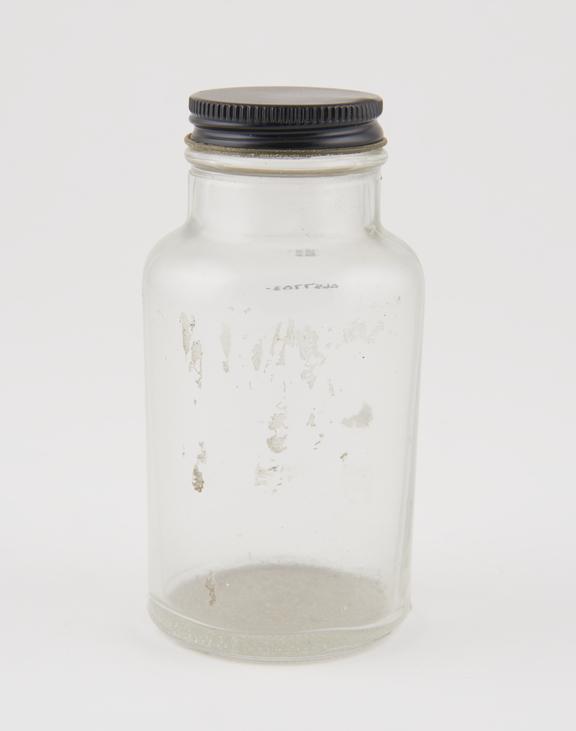 Clear glass storage jar with metal screw-on cap, stippled base