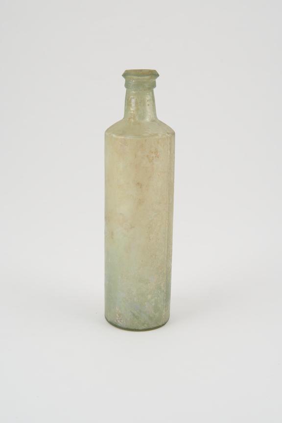 Glass bottle, tall cylindrical, weathered, mould marks on sides