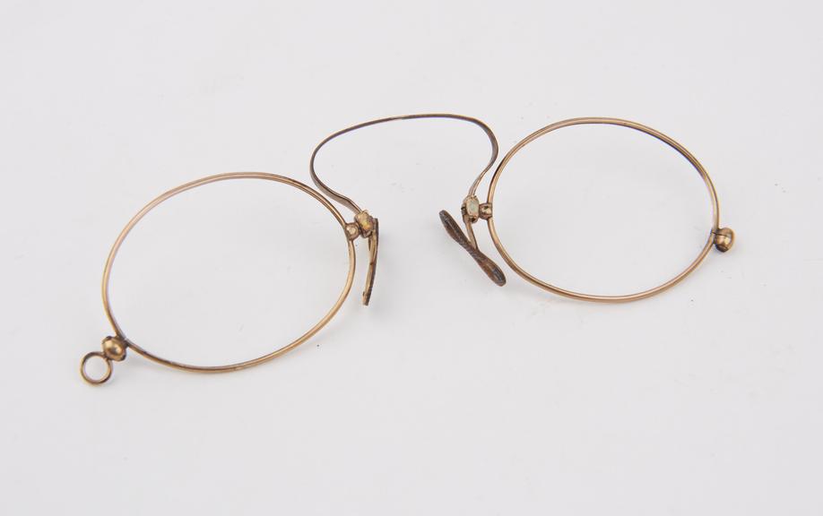 Gold adjustable clip eyeglasses with oval lenses (no lenses