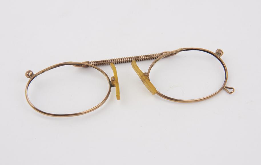 Gold adjustable clip spectacles with oval lenses and cork lined