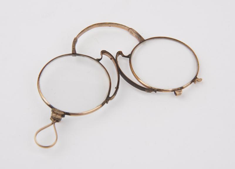 Gold bow-spring folding eyeglasses with round lenses