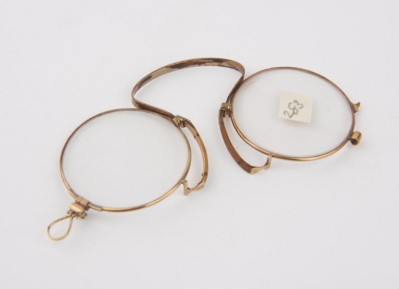 Gold bow-spring folding eyeglasses with round lenses