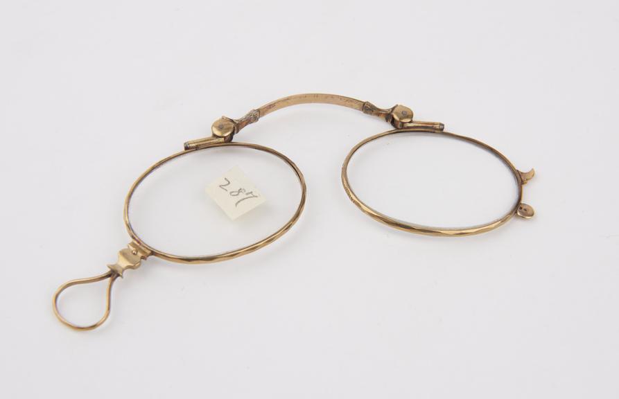 Gold folding eyeglasses with double action coiled springs and