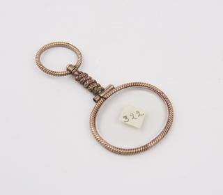Single oval eyeglasses in knurled gold (?) frame w