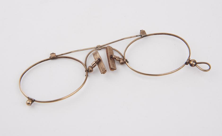 Gold wire framed eyeglasses with 'Revluc' patent clip and oval