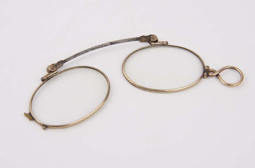 Gold folding eyeglasses , large eyes