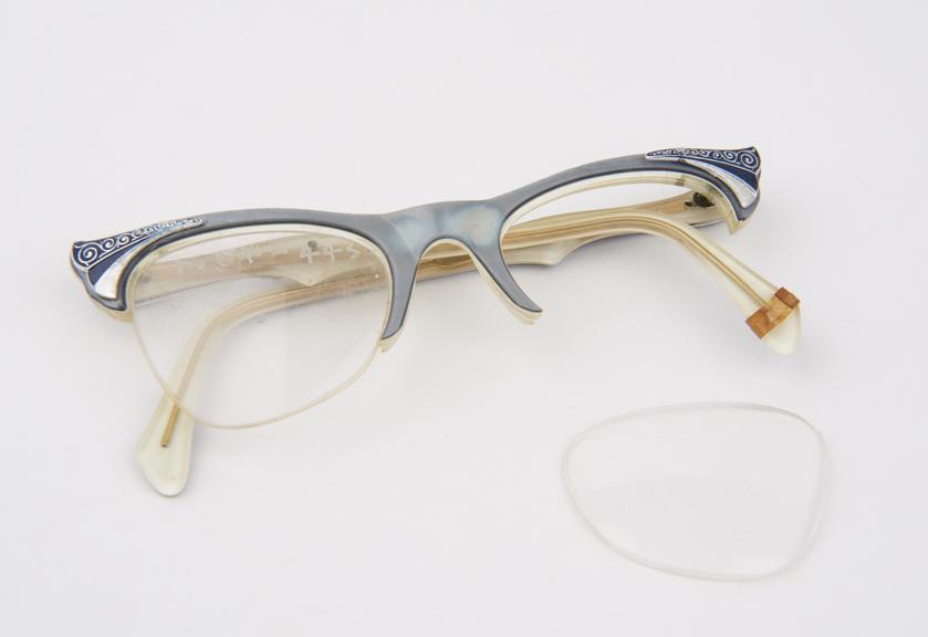 Pair of spectacles with grey plastic layer on green/ yellow