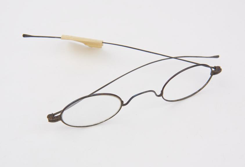 Pair of brass rimmed spectacles, circular lenses, lens missing