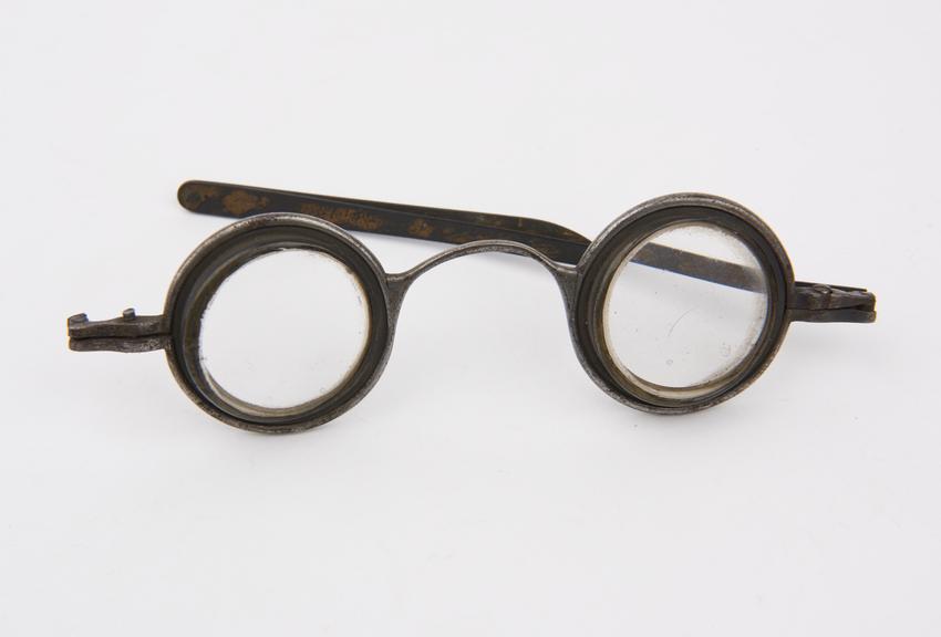 Pair of steel-framed spectacles with prismatic eyepieces